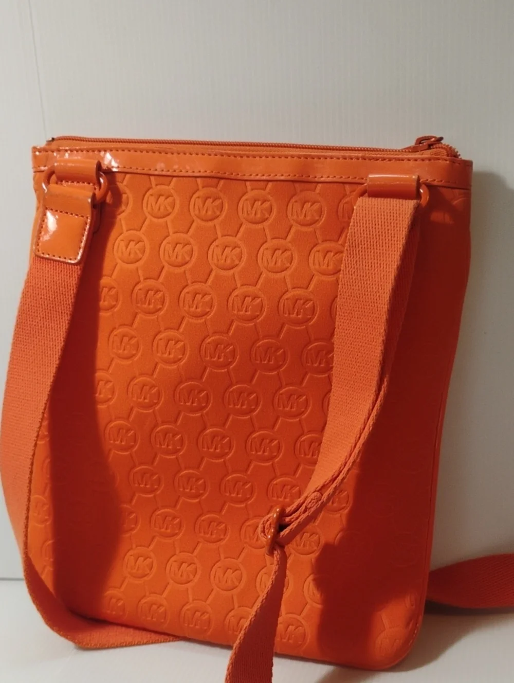 Michael Kors Neoprene Tangerine Mono Embossed Swing Crossbody bag